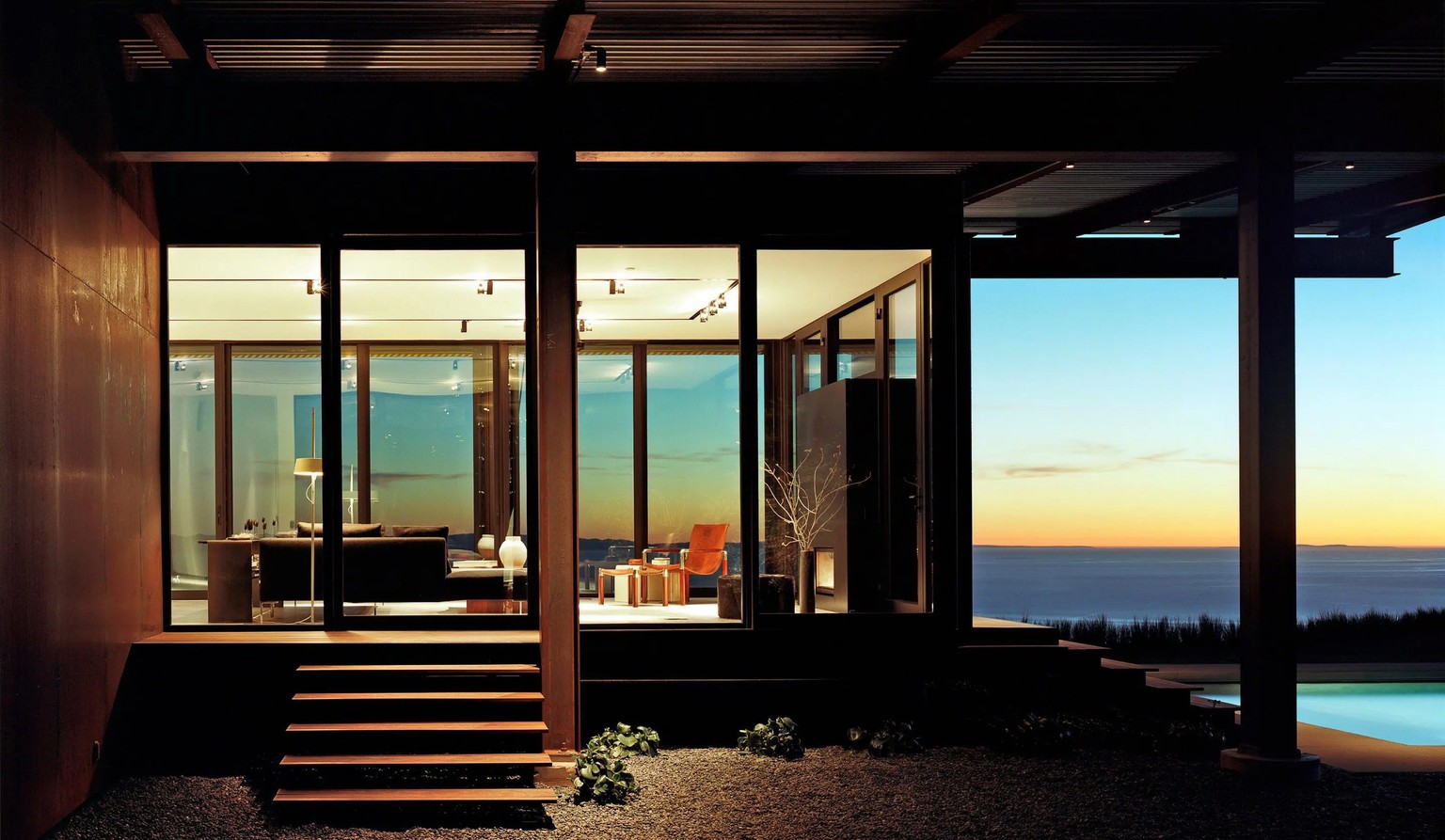 Modern home at twilight overlooking the ocean